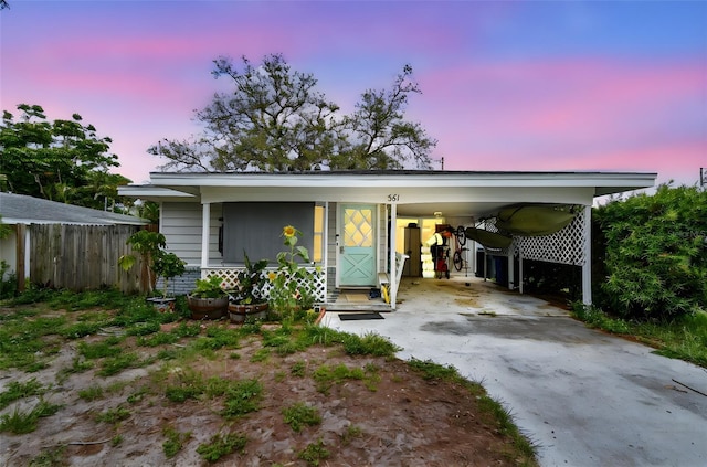 361 Colonial Ct, Dunedin, FL 34698 - view of front facade with driveway, a porch, and an attached carport