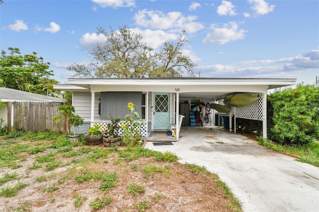 361 Colonial Ct, Dunedin, FL 34698 - view of front of house with driveway and a carport