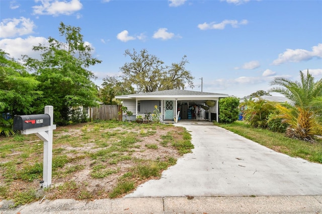361 Colonial Ct, Dunedin, FL 34698 - view of front of home featuring concrete driveway and an attached carport