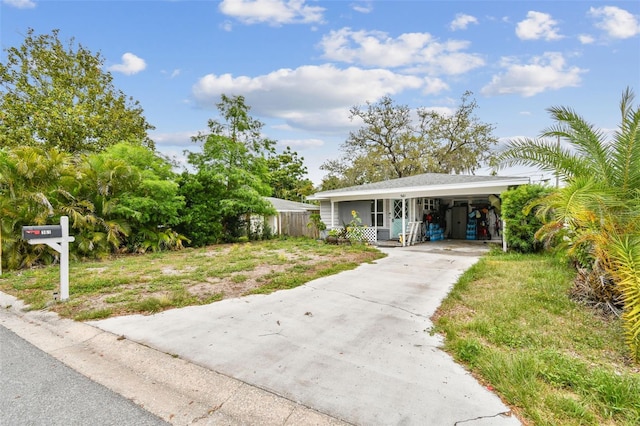 361 Colonial Ct, Dunedin, FL 34698 - view of front of property with driveway and a carport