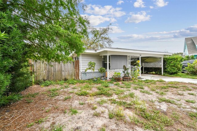 361 Colonial Ct, Dunedin, FL 34698 - view of home's exterior featuring an attached carport and concrete driveway
