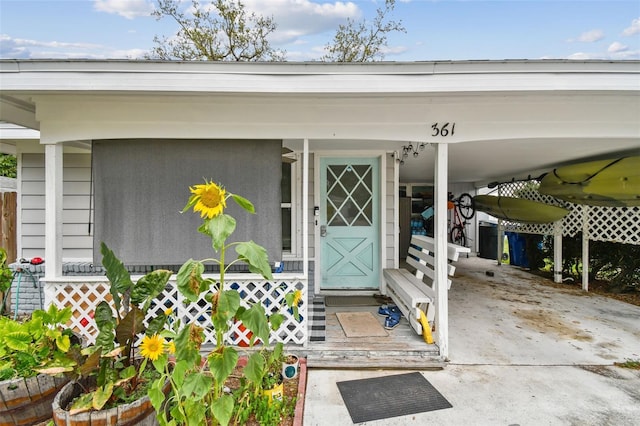 361 Colonial Ct, Dunedin, FL 34698 - doorway to property featuring a carport