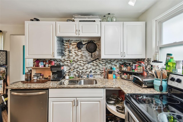 361 Colonial Ct, Dunedin, FL 34698 - kitchen with appliances with stainless steel finishes, white cabinets, and a sink