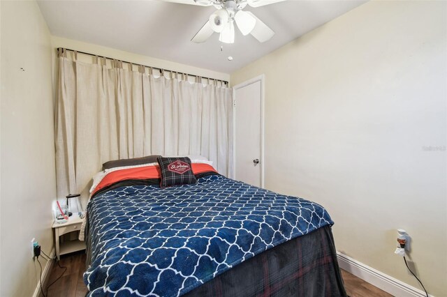 361 Colonial Ct, Dunedin, FL 34698 - bedroom with wood finished floors, baseboards, baseboard heating, and ceiling fan