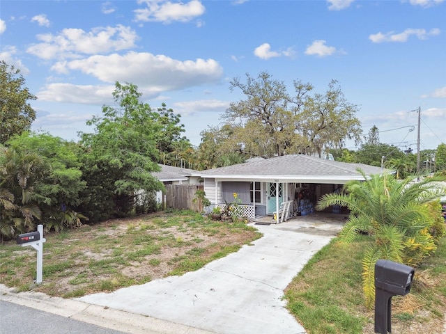 361 Colonial Ct, Dunedin, FL 34698 - view of front facade with concrete driveway and a carport