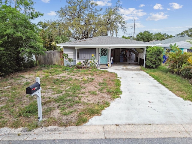 361 Colonial Ct, Dunedin, FL 34698 - bungalow-style home featuring concrete driveway and an attached carport
