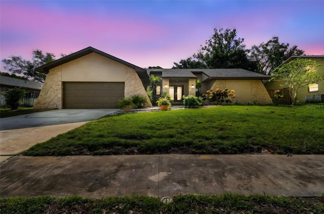 854 Village Way, Palm Harbor, FL 34683 - mid-century home featuring an attached garage, a lawn, driveway, stucco siding, and french doors