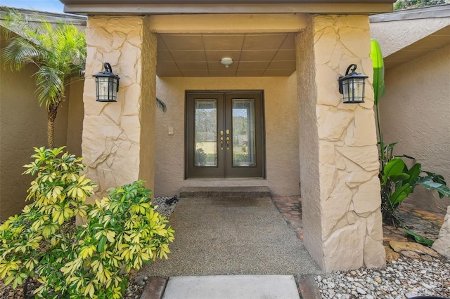 854 Village Way, Palm Harbor, FL 34683 - view of exterior entry with french doors, stucco siding, and stone siding