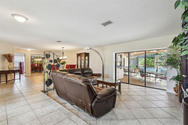 854 Village Way, Palm Harbor, FL 34683 - living room featuring a chandelier, light tile patterned floors, and a textured ceiling