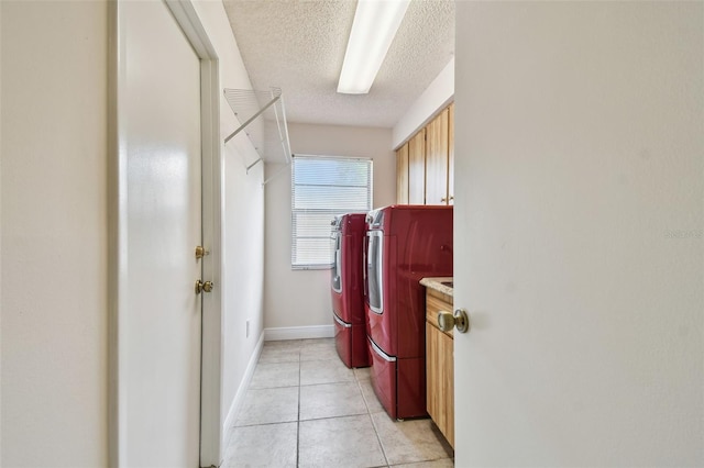 854 Village Way, Palm Harbor, FL 34683 - washroom featuring independent washer and dryer, cabinet space, a textured ceiling, light tile patterned flooring, and baseboards