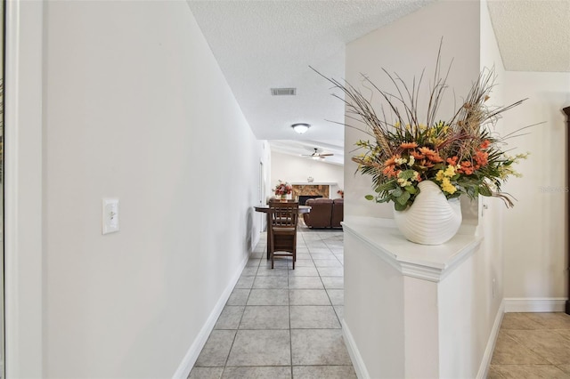 854 Village Way, Palm Harbor, FL 34683 - hall with light tile patterned floors and a textured ceiling