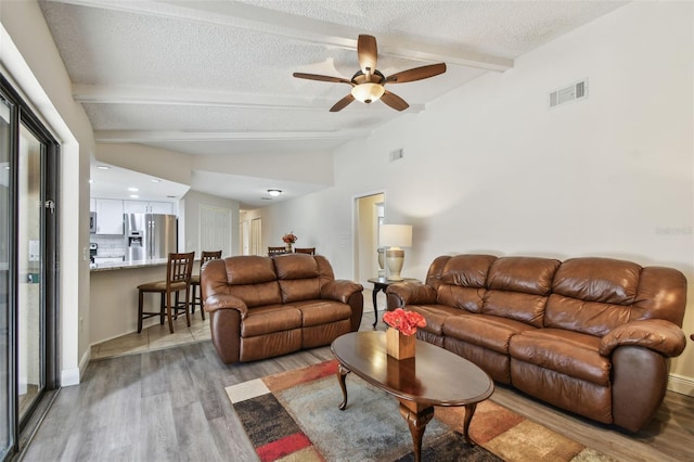 854 Village Way, Palm Harbor, FL 34683 - living area with light wood-type flooring, ceiling fan, and a textured ceiling