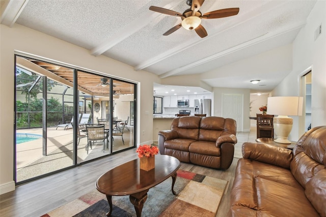 854 Village Way, Palm Harbor, FL 34683 - living area with a ceiling fan, light wood-style flooring, a textured ceiling, and baseboards