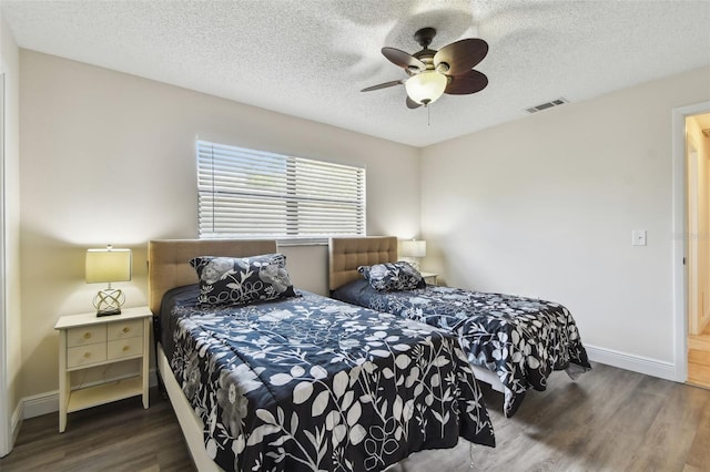854 Village Way, Palm Harbor, FL 34683 - bedroom featuring wood finished floors, baseboards, ceiling fan, and a textured ceiling