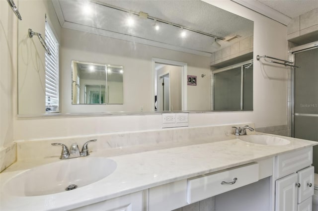 854 Village Way, Palm Harbor, FL 34683 - bathroom featuring a stall shower, double vanity, track lighting, and a textured ceiling