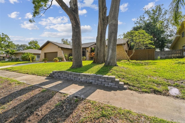854 Village Way, Palm Harbor, FL 34683 - view of front facade featuring a garage, stucco siding, and driveway