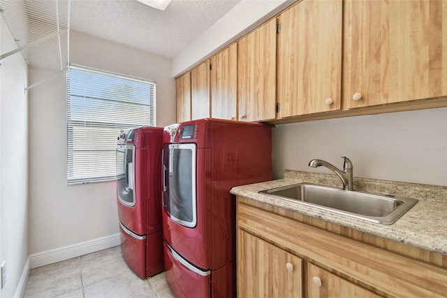 854 Village Way, Palm Harbor, FL 34683 - clothes washing area with washing machine and clothes dryer, baseboards, cabinet space, light tile patterned flooring, and a textured ceiling