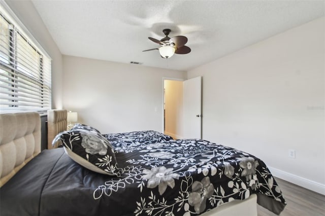 854 Village Way, Palm Harbor, FL 34683 - bedroom featuring wood finished floors, baseboards, a ceiling fan, and a textured ceiling