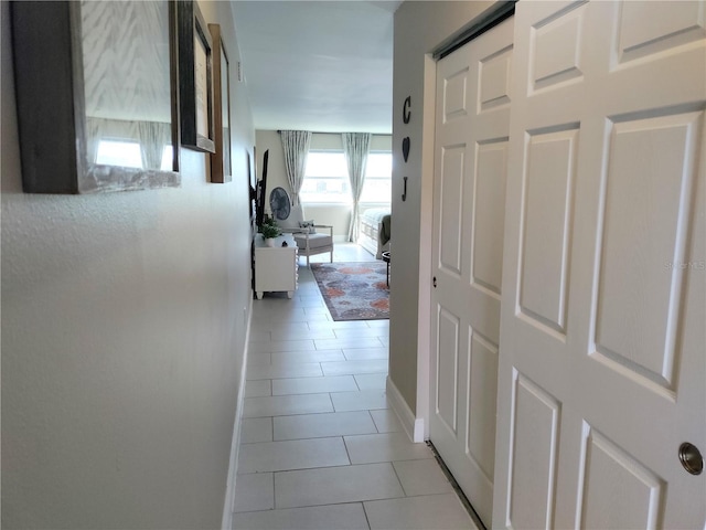 3850 13th Ave N Unit 311, Saint Petersburg, FL 33713 - hallway with light tile patterned flooring and baseboards