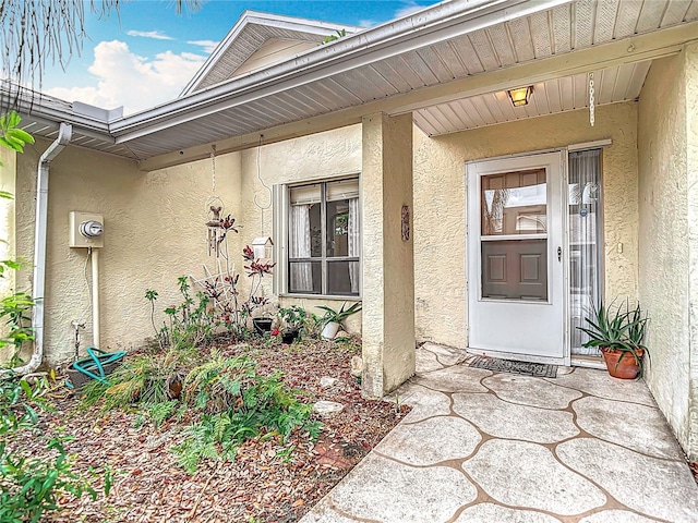 120 Colony S Dr, Tarpon Springs, FL 34689 - doorway to property featuring stucco siding and a porch