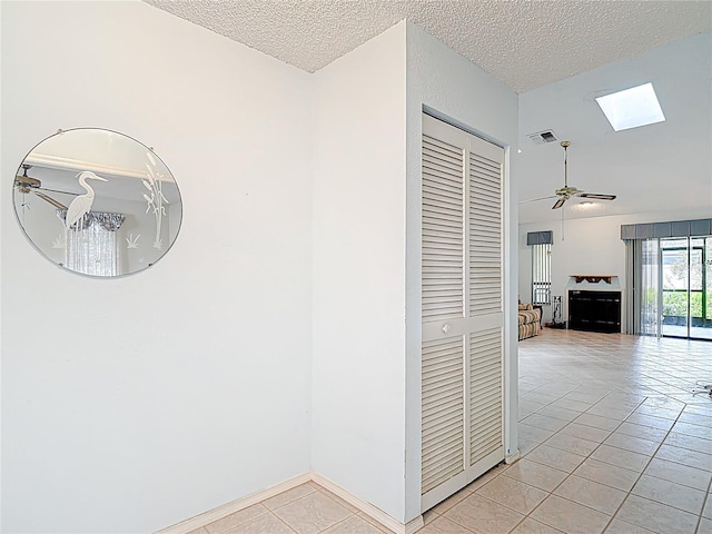 120 Colony S Dr, Tarpon Springs, FL 34689 - corridor with a skylight, light tile patterned floors, and a textured ceiling