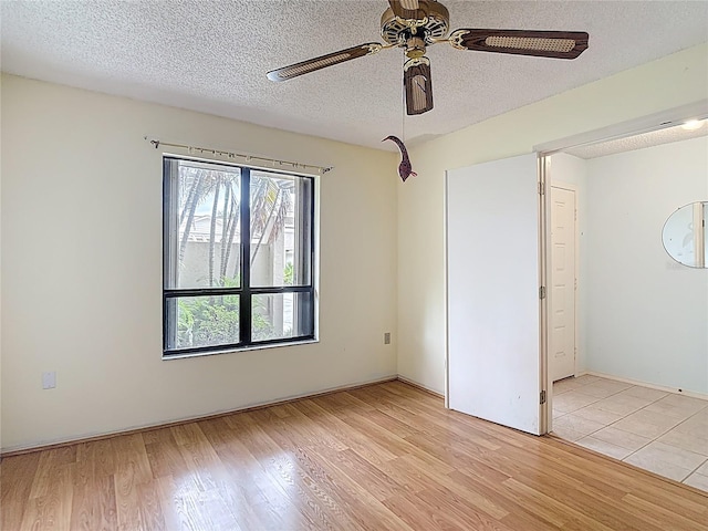 120 Colony S Dr, Tarpon Springs, FL 34689 - empty room featuring light wood-style flooring, ceiling fan, and a textured ceiling