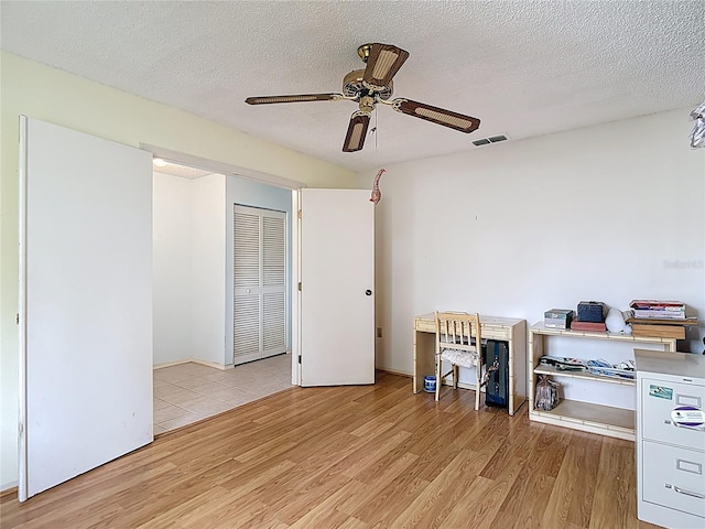 120 Colony S Dr, Tarpon Springs, FL 34689 - office space featuring light wood-style flooring, a ceiling fan, and a textured ceiling