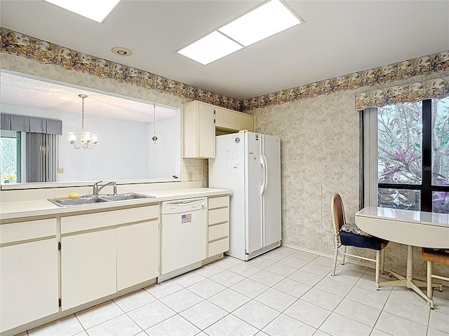 120 Colony S Dr, Tarpon Springs, FL 34689 - kitchen featuring white appliances, a sink, a chandelier, light countertops, and wallpapered walls