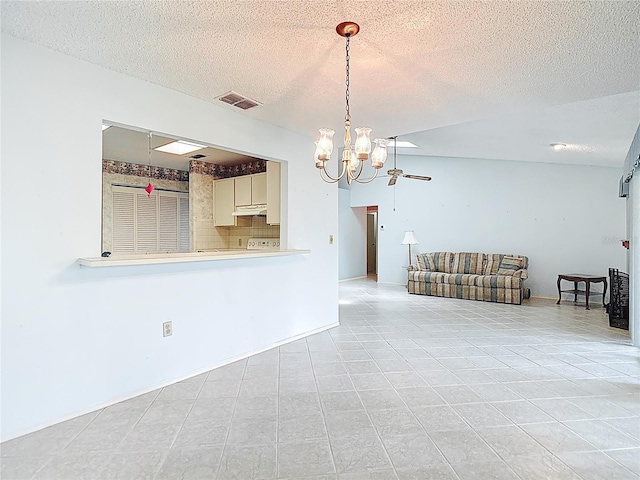 120 Colony S Dr, Tarpon Springs, FL 34689 - spare room featuring a chandelier, a textured ceiling, and light tile patterned flooring