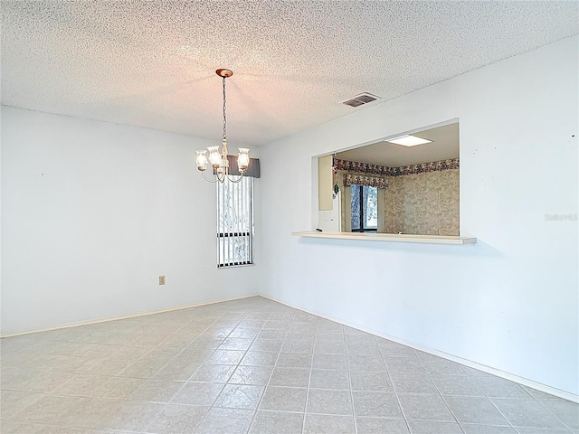 120 Colony S Dr, Tarpon Springs, FL 34689 - spare room with a chandelier and a textured ceiling
