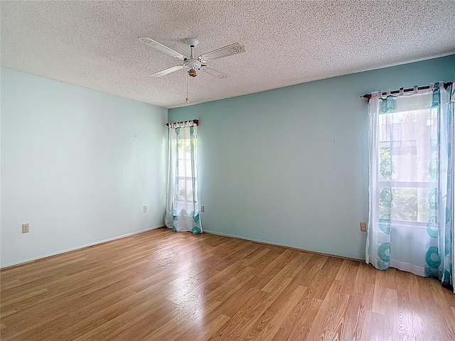 120 Colony S Dr, Tarpon Springs, FL 34689 - empty room featuring light wood finished floors, a ceiling fan, and a textured ceiling