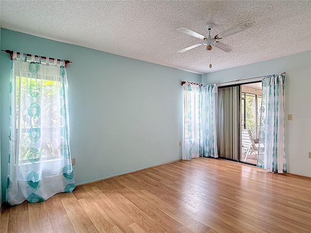 120 Colony S Dr, Tarpon Springs, FL 34689 - spare room featuring a textured ceiling, wood finished floors, ceiling fan, and baseboards