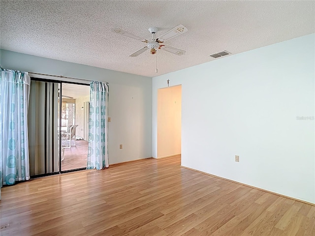 120 Colony S Dr, Tarpon Springs, FL 34689 - empty room with light wood finished floors, ceiling fan, and a textured ceiling