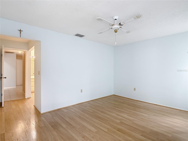 120 Colony S Dr, Tarpon Springs, FL 34689 - empty room with light wood-style flooring, ceiling fan, and baseboards