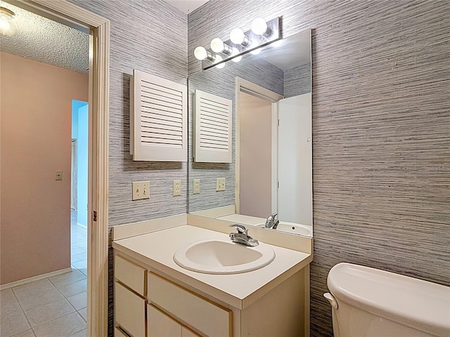 120 Colony S Dr, Tarpon Springs, FL 34689 - bathroom with toilet, tile patterned floors, vanity, and baseboards