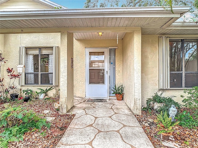 120 Colony S Dr, Tarpon Springs, FL 34689 - doorway to property with stucco siding and covered porch