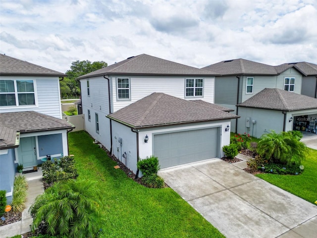 9324 Rally Spring Loop, Wesley Chapel, FL 33545 - view of front of home with a garage, concrete driveway, a front yard, and roof with shingles
