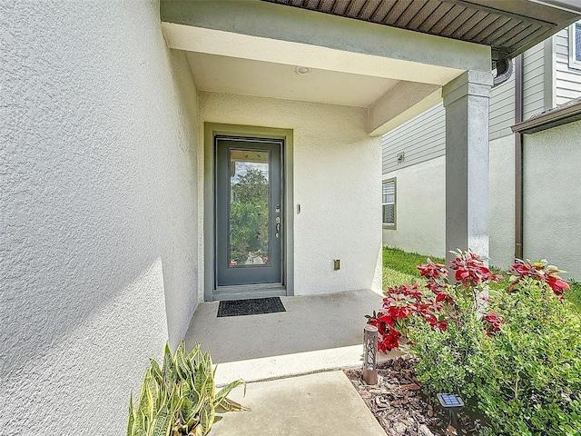 9324 Rally Spring Loop, Wesley Chapel, FL 33545 - doorway to property featuring stucco siding