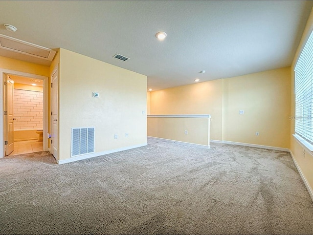 9324 Rally Spring Loop, Wesley Chapel, FL 33545 - carpeted spare room featuring baseboards, attic access, a smoke detector, and recessed lighting