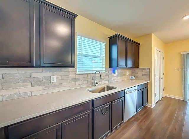 9324 Rally Spring Loop, Wesley Chapel, FL 33545 - kitchen featuring a sink, stainless steel dishwasher, dark wood-style floors, backsplash, and light countertops