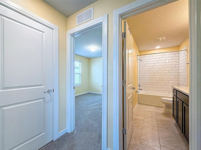 9324 Rally Spring Loop, Wesley Chapel, FL 33545 - full bath with a textured ceiling, toilet, vanity, shower / tub combination, and baseboards
