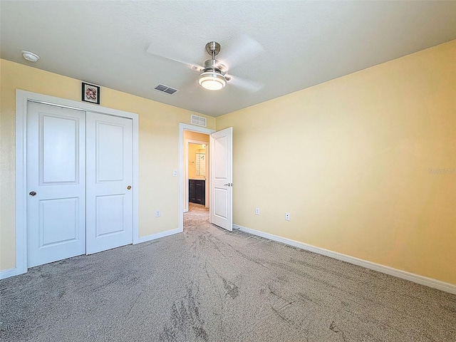 9324 Rally Spring Loop, Wesley Chapel, FL 33545 - unfurnished bedroom featuring carpet flooring, baseboards, a closet, and a ceiling fan