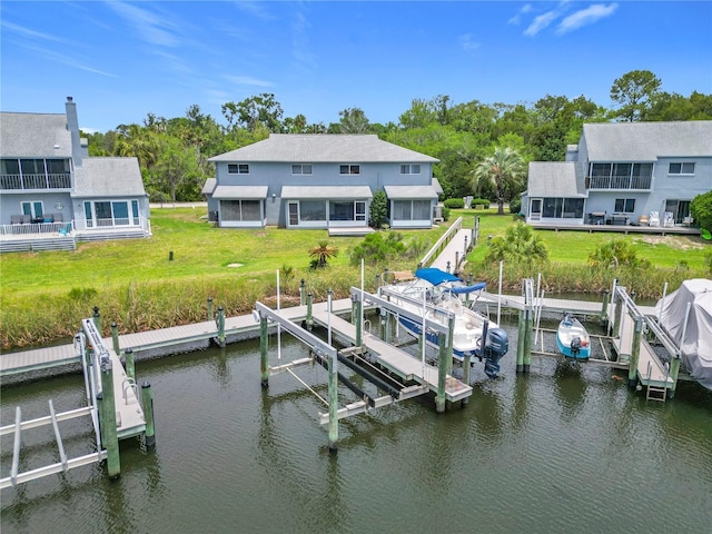 11122 W Cove Harbor Dr Unit 112, Crystal River, FL 34428 - dock area with boat lift, a water view, and a lawn