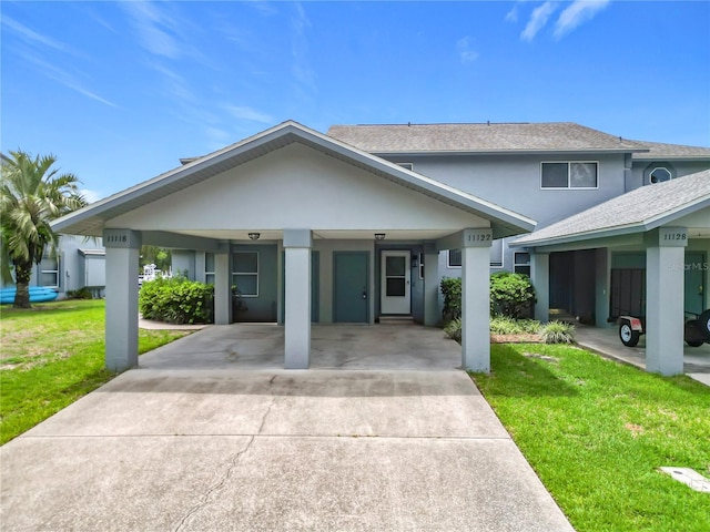 11122 W Cove Harbor Dr Unit 112, Crystal River, FL 34428 - view of front of home featuring stucco siding, a front yard, concrete driveway, and a carport