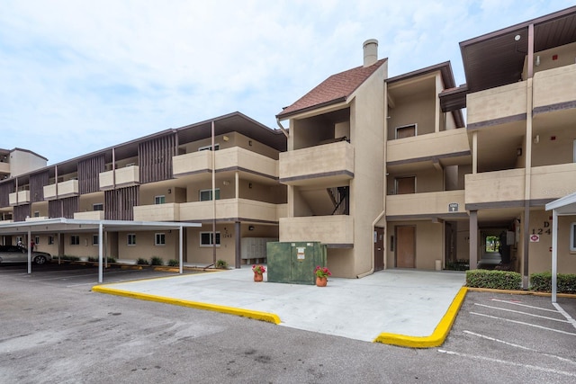1241 S Martin Luther King Jr Ave Unit 302, Clearwater, FL 33756 - view of apartment building / complex with uncovered parking