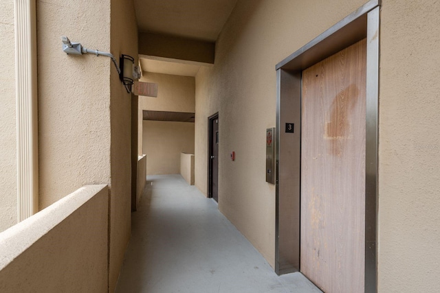 1241 S Martin Luther King Jr Ave Unit 302, Clearwater, FL 33756 - hall with concrete floors, elevator, and a textured wall