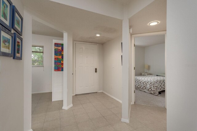 1241 S Martin Luther King Jr Ave Unit 302, Clearwater, FL 33756 - corridor featuring baseboards and light tile patterned flooring