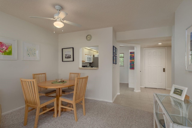 1241 S Martin Luther King Jr Ave Unit 302, Clearwater, FL 33756 - dining space with a ceiling fan, light tile patterned floors, baseboards, light carpet, and a textured ceiling