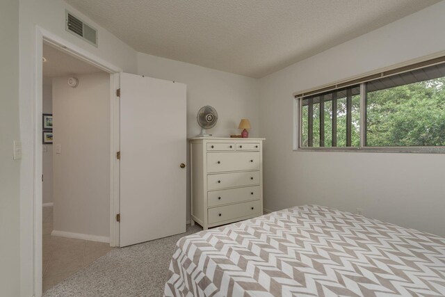 1241 S Martin Luther King Jr Ave Unit 302, Clearwater, FL 33756 - tiled bedroom with a textured ceiling