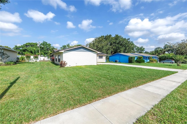 4821 S Gachet Blvd, Lakeland, FL 33813 - view of property exterior featuring driveway and a lawn